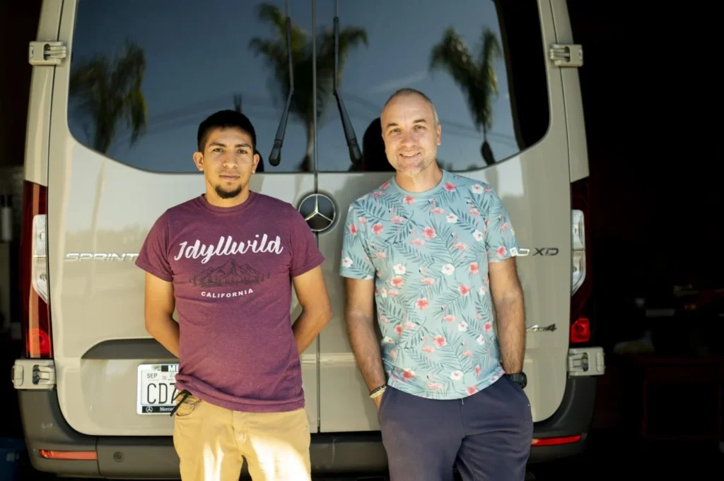 The Exmotech team standing in front of a van.